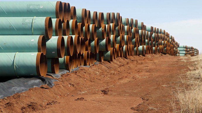 FILE - In this Wednesday, Feb. 1, 2012 file photo, miles of pipe ready to become part of the Keystone Pipeline are stacked in a field near Ripley, Okla. President Barack Obama says that the proposed Keystone XL pipeline project from Canada to Texas should only be approved if it doesn't worsen carbon pollution. Obama says allowing the oil pipeline to be built requires a finding that doing so is in the nation's interest. He says that means determining that the pipeline does not contribute and "significantly exacerbate" emissions. (AP Photo/Sue Ogrocki, File)