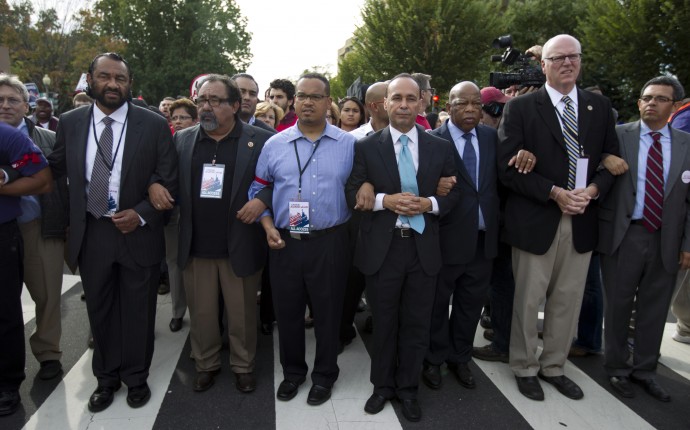 From left, Rep. Al Green, D-Texas, Rep. Raul Grijalva, D-Ariz., Rep. Keith Ellison, D-Minn., Rep. Luis Gutierrez D-Ill., Rep. John Lewis, D-Ga., and Rep. Joseph Crowley, D-N.Y., second from right, march on Capitol Hill during a immigration rally in Washington, on Tuesday, Oct. 8, 2013, seeking to push Republicans to hold a vote on a stalled immigration reform bill. (AP Photo/Jose Luis Magana)