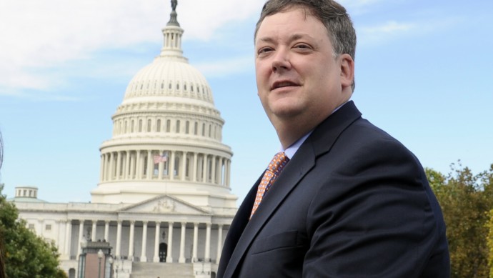 Republican activist Shaun McCutcheon of Hoover, Ala. walks past the Capitol as he leaves the Supreme Court in Washington, Tuesday, Oct. 8, 2013, after the court's hearing on campaign finance. The Supreme Court is tackling a challenge to limits on contributions by the biggest individual donors to political campaigns. McCutcheon, the national Republican Party and Senate Minority Leader Mitch McConnell of Ky. want the court to overturn the overall limits on what contributors may give in a two-year federal election cycle.  (AP Photo/Susan Walsh)