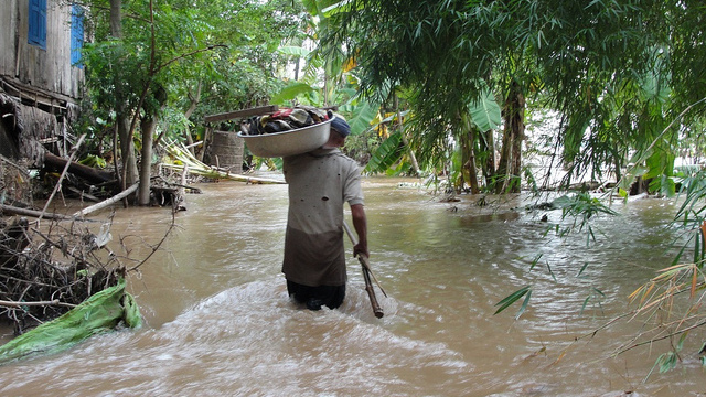 A man walking through flood waters in the Koh Ta Ngor village of Cambodia in this Oct. 11, 2011 photo. (Photo/ Thearat Touch via European Commission DG ECHO/Flickr)