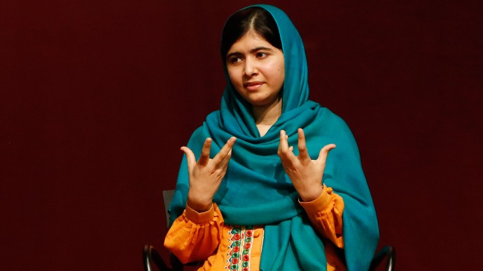 Malala Yousafzai gestures as she speaks to an audience during a discussion of her book, "I am Malala" hosted by the John F. Kennedy Library and held at Boston College High School Saturday, Oct. 12, 2013, in Dorchester, Mass. The Pakistani teenager, an advocate for education for girls, survived a Taliban assassination attempt last year on her way home from school.  (AP Photo/Jessica Rinaldi)