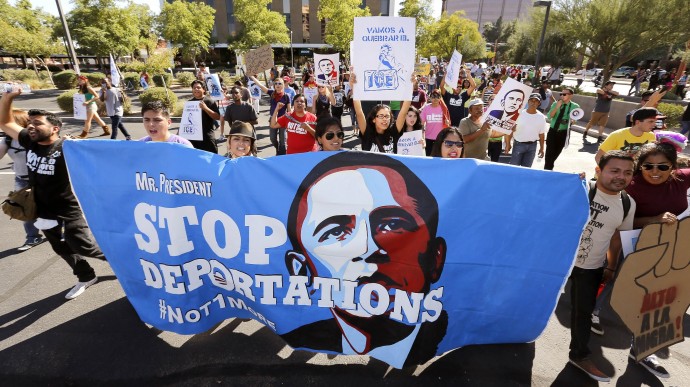 Upset with President Barack Obama's immigration policy, about 250 people march to the U.S. Immigrations and Customs Enforcement office with a goal of stopping future deportations on Monday Oct. 14, 2013, in Phoenix.  The protesters chanted "no more deportations" and "shut down ICE." (AP Photo/Ross D. Franklin)