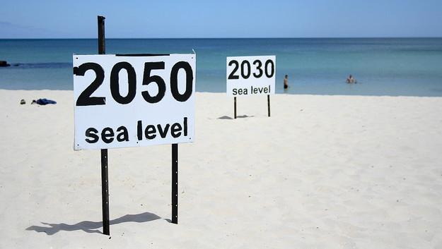 Signs stating predictions of where rising sea levels will end up at Cottesloe Beach in Perth, Australia in this Nov. 18, 2008 photo. (Photo/go_greener_oz via Flickr)