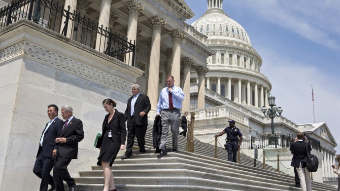 FILE - In this Friday, Aug. 2, 2013, file photo, members of Congress walk down the steps of the House of Representatives on Capitol Hill in Washington. The Treasury reports on the budget deficit for August on Thursday, Sept. 12, 2013. (AP Photo/J. Scott Applewhite, File)