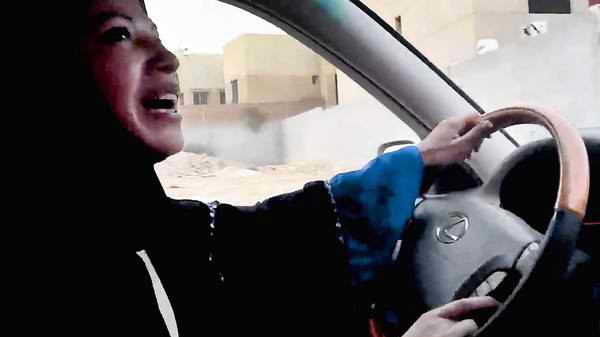 A Saudi woman driving in a car for women's rights and against a driving ban. (Photo/Robert Reed Daly via Flickr)