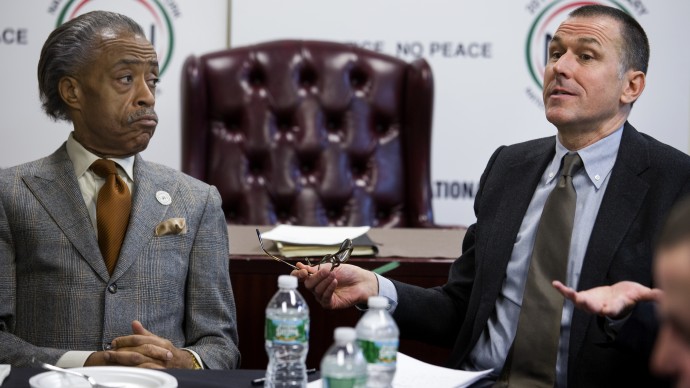 The Rev. Al Sharpton, left, listens as he meets with Mark Lee, CEO of Barneys New York, Tuesday, Oct. 29, 2013, at the National Action Headquarters in New York, to discuss allegations of racial profiling at the high-end retailer. Two black customers recently claimed they were detained by police on suspicion of credit card fraud after lawfully purchasing expensive items. (AP Photo/Craig Ruttle)