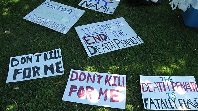 Signs from a death penalty protest in Seattle, Washington in this July 6, 2006 photo. (Photo/javacolleen via Flickr)