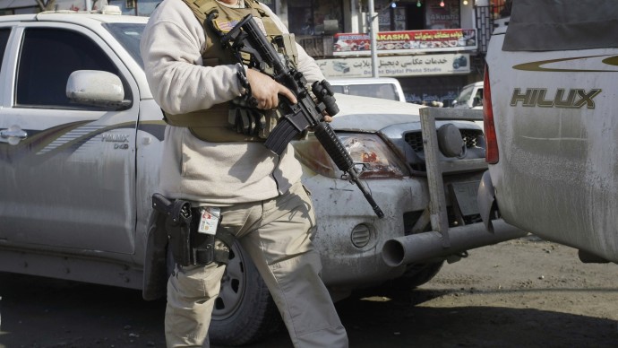 US PMC A member of security escorts a U.S. convoy in to the Kabul police headquarters, where a an American advisor was killed in Kabul, Afghanistan, Monday, Dec. 24, 2012. (AP Photo/Musadeq Sadeq)