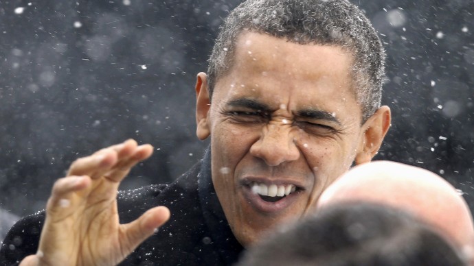 President Barack Obama waves to the crowd as he walks through a snowstorm after getting of Air Force One in Manchester, N.H. ,Thursday, March 1, 2012, on his way to speak at the Nashua (N.H.) Community College. (AP Photo/Winslow Townson)