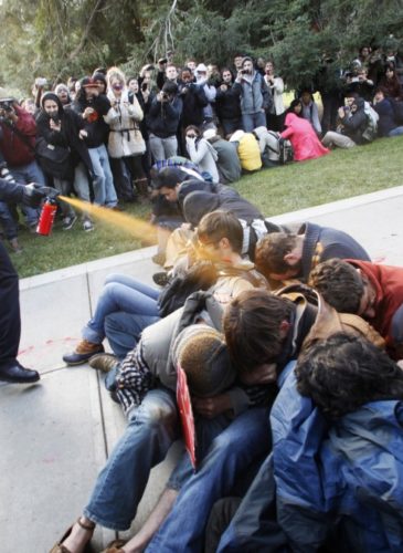University of California, Davis Police Lt. John Pike uses pepper spray to move Occupy UC Davis protesters(AP Photo/The Enterprise, Wayne Tilcock)
