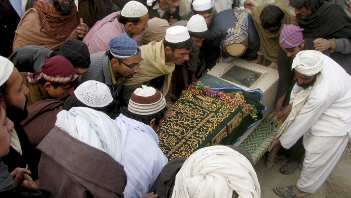 FILE - In this Dec. 29, 2010, file photo, Pakistani villagers carry the shrouded casket of a person reportedly killed by a US drone attack in Pakistani tribal area of Mir Ali along the Afghanistan border, during his funeral in Bannu, Pakistan. The Shamsi airfield in southwest Pakistan has become the centre of a political storm about Pakistan surrendering its sovereignty, as the airfield is suspected of housing U.S. drones used in missile strikes in Pakistan, but is actually under the control of the United Arab Emirates, although a UAE official has denied that the Gulf state has any operational role. (AP Photo/Ijaz Muhammad, file)