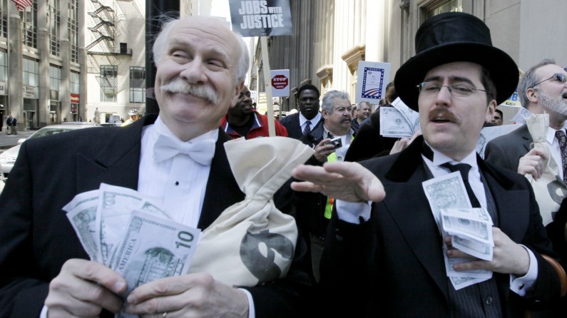 Protesters Richard Hanzel, left, Brendan Hutt, and Richard Shavzin, right, of the Screen Actors Guild, dressed as wall street bankers, march from Goldman Sachs' office to a rally in Federal Plaza demanding Wall Street reform, Wednesday, April 28, 2010, in Chicago. The rally  was organized by the Chicago Federation of Labor which includes more than 300 unions with more than 500,000 members. (AP Photo/M. Spencer Green)