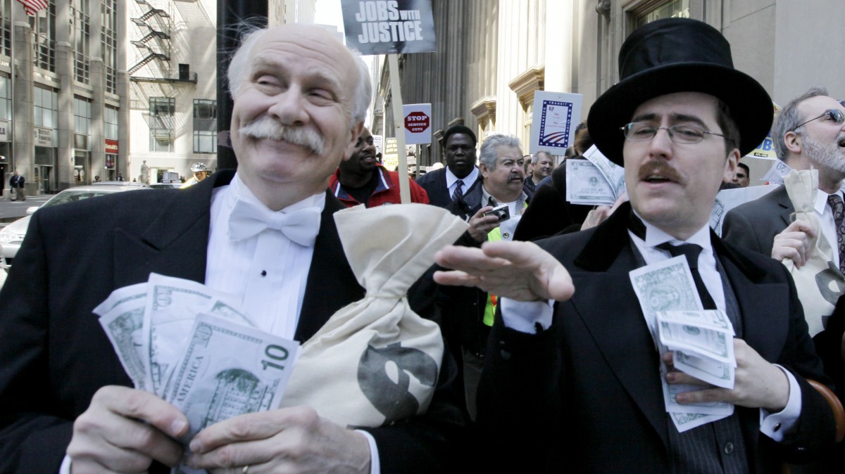 Protesters Richard Hanzel, left, Brendan Hutt, and Richard Shavzin, right, of the Screen Actors Guild, dressed as wall street bankers, march from Goldman Sachs' office to a rally in Federal Plaza demanding Wall Street reform, Wednesday, April 28, 2010, in Chicago.