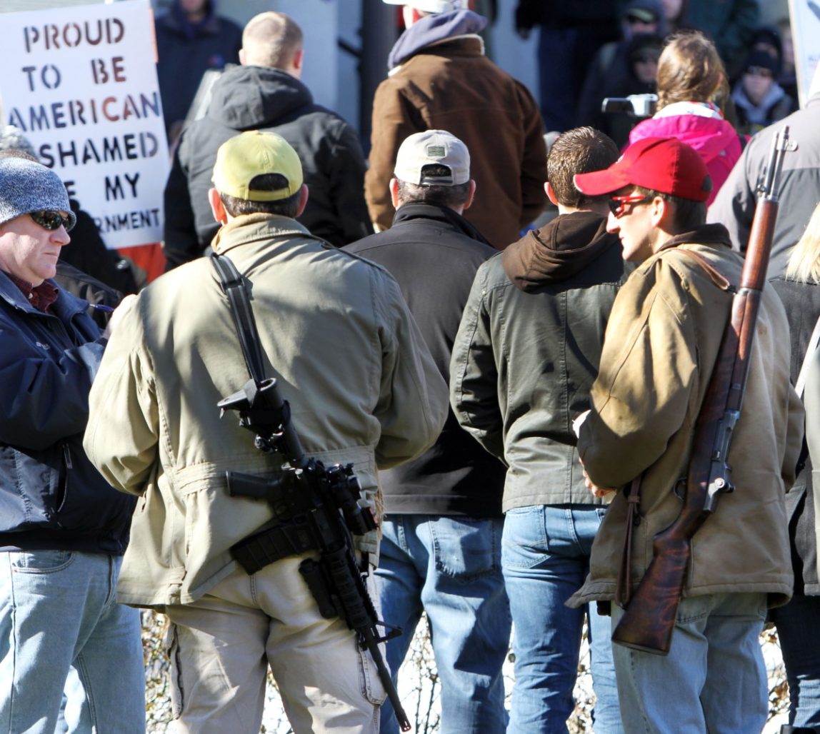 In this Thursday Jan. 31, 2013 file photo, gun owners rally to promote the right to bear arms in front of the Statehouse in Concord, N.H. (AP Photo/Jim Cole, File)