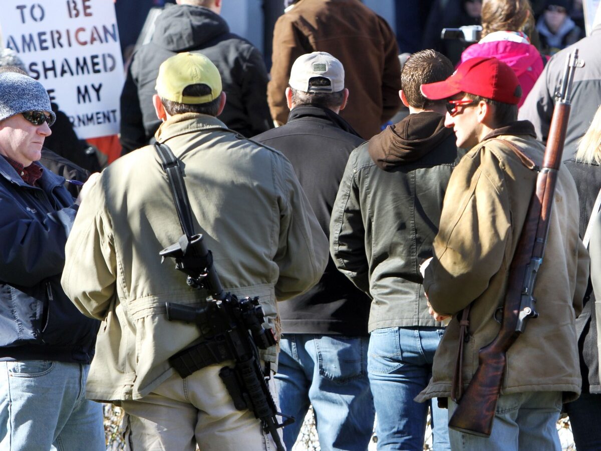 In this Thursday Jan. 31, 2013 file photo, gun owners rally to promote the right to bear arms in front of the Statehouse in Concord, N.H. (AP Photo/Jim Cole, File)