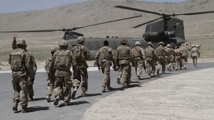 NATO solders walk towards a Chinook helicopter after a ceremony at a military academy on the outskirts of Kabul, Afghanistan, Tuesday, June 18, 2013. As Afghan forces take over the lead from the NATO coalition for security nationwide, European nations are drawing down their militaries in response to the ongoing economic crises. (AP/Rahmat Gul)