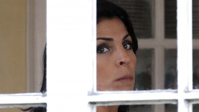 Jill Kelley looks out the window of her home Tuesday, Nov 12, 2012 in Tampa, Fla. Kelley is identified as the woman who allegedly received harassing emails from Gen. David Petraeus' paramour, Paula Broadwell. She serves as an unpaid social liaison to MacDill Air Force Base in Tampa, where the military's Central Command and Special Operations Command are located. (AP Photo/Chris O'Meara)