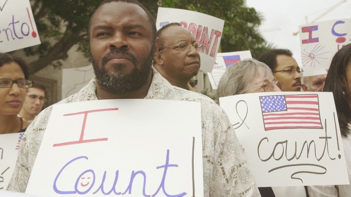 Felon Leroy Jones joins other demontsrators outside court in Miami, Wednesday, April 9, 2003, where the 11th U.S. Circuit Court of Appeals is hearing arguments on whether the state is doing enough to help ex-felons restore their voting rights. Jones finished his sentence 10 years ago. (AP Photo/J. Pat Carter)