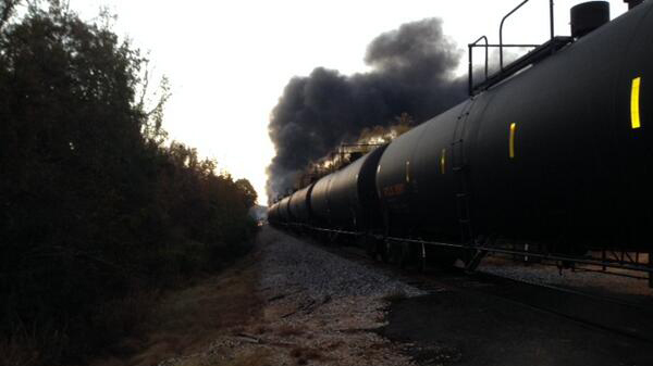 In this photo released by the Alabama Emergency Management Agency on Friday, Nov. 8, 2013, a tanker train carrying crude oil burns after derailing in western Alabama outside Aliceville, Ala., early Friday, sending flames and black smoke into the air and temporarily forcing one family to leave their home. Emergency officials said three train cars exploded overnight in Pickens County which is near the Mississippi/Alabama line. A dozen cars derailed and nine were damaged. (AP Photo/Alabama Emergency Management Agency)