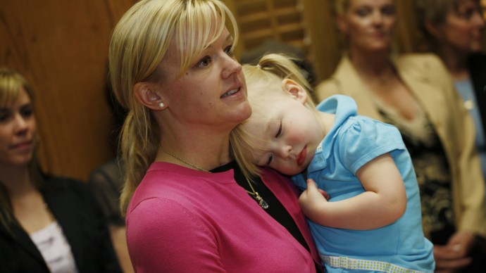 Jessica Corry holds her 2-year-old daughter, Caroline, during a news conference to launch the Women's Marijuana Movement in the State Capitol in downtown Denver on Thursday, May 6, 2010. (AP Photo/David Zalubowski)