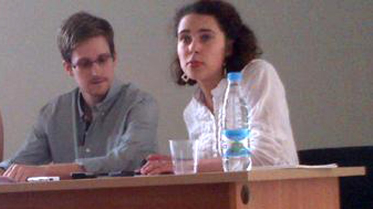 This image provided by Human Rights Watch shows NSA leaker, Edward Snowden, centre, attends a press conference at Moscow's Sheremetyevo Airport with Sarah Harrison of WikiLeaks, left,  Friday, July 12, 2013. (AP Photo/Human Rights Watch, Tanya Lokshina)