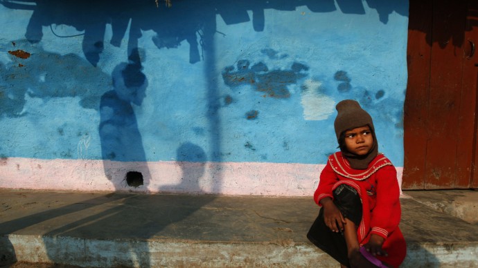 An Indian girl sits outside her home at a slum area, in Allahabad, India, Thursday, Nov. 21, 2013. Newly released census data shows families living in slums have a far better child sex ratio than the urban Indian average. The child sex ratio (children from 0-6 years old) of an average slum household is 922 girls for every 1,000 boys, compared to 905 for urban households in India. Over a third of India’s slum dwellers live in unrecognized slums. (AP Photo/Rajesh Kumar Singh)