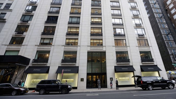 FILE - In this Monday, Oct. 28, 2013, file photo, pedestrians pass Barneys New York department store in New York. Rap artist Jay-Z has said he’s been unfairly “demonized” because he hasn’t backed out of his collaboration with Barneys New York, accused of racially profiling two black customers.  (AP Photo/Frank Franklin II, File)