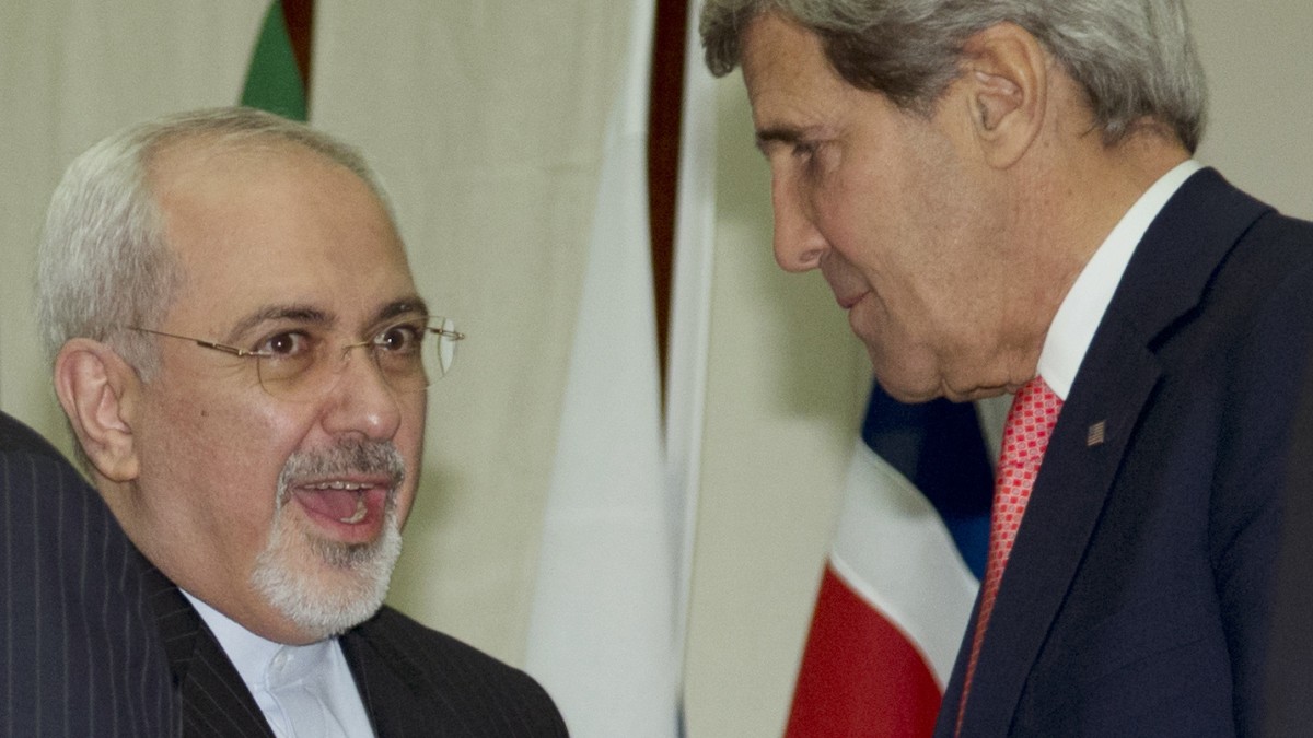 U.S. Secretary of State John Kerry, right, and Iranian Foreign Minister Mohammad Javad Zarif, shake hands at the United Nations Palais, Sunday, Nov. 24, 2013, in Geneva, Switzerland.