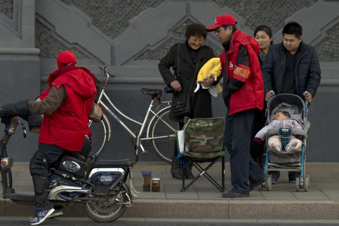 In this photo taken Tuesday, Nov. 12, 2013, a child rest in a stroller on the streets of Beijing, China. China will loosen its decades-old one-child policy by allowing two children for families with one parent who was an only child and will abolish a much-criticized labor camp system, its ruling Communist Party said Friday, Nov. 15, 2013. (AP Photo/Ng Han Guan)
