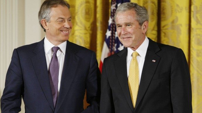 President George W. Bush and former British Prime Minister Tony Blair nudge each other in the East Room of the White House in Washington, Tuesday, Jan. 13, 2009, during a ceremony where the president presented Blair with the Presidential Medal of Freedom. (AP Photo/Gerald Herbert)