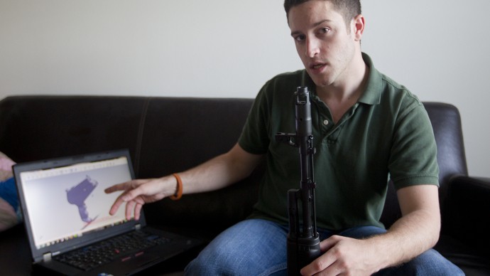 10.03.12 Alberto Mart'nez AMERICAN-STATESMAN - Cody Wilson points to to his laptop screen where an image of a prototype plastic on the screen, with his other hand he holds a weapon he calls 'Invivdual Mandate.' Wilson bought a 3-d printer, he planned to print a the prototype but before he was able to, the company that made the printer sent a representative to confiscate it. Still, he's certain the gun will be printed. 'This is coming,' he says, 'whether it's me, or somebody else. This your printable future.'