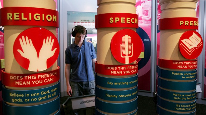 Thomas Whittington, a Chicago area tour guide, familiarizes himself with the one of many exhibits at the new McCormick Tribune Freedom Museum in Chicago. The exhibit is one of many that are designed to help visitors, especially teenagers, understand the First Amendment freedoms: freedom of speech, religion, press, assembly and petition for redress of grievances. (AP Photo/Charles Rex Arbogast)