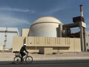 FILE - In this Oct. 26, 2010 file photo, a worker rides a bicycle in front of the reactor building of the Bushehr nuclear power plant, just outside the southern city of Bushehr, Iran. A report by Iran's official news agency quotes the country's nuclear chief, Ali Akbar Salehi, saying the Islamic Republic needs more nuclear power plants, just after it struck a deal regarding its contested nuclear program with world powers. Salehi said Iran is in serious talks with several countries including Russia to build four more nuclear power plants.(AP Photo/Mehr News Agency, Majid Asgaripour, File)