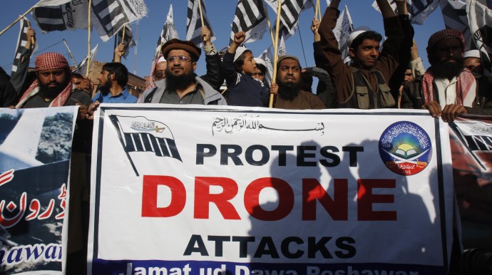 Supporters of Pakistani religious group Jamaat-ud-Dawa rally to condemn U.S. drone attacks in Pakistani tribal areas, Friday, Nov. 29, 2013 in Peshawar, Pakistan. A suspected U.S. drone strike killed an alleged militant in Pakistan's northwest tribal region, intelligence officials said Friday, the latest indication Washington has no intention of throttling back its unmanned aircraft attacks despite increasing tension with Pakistan over the attacks. (AP Photo/Mohammad Sajjad)