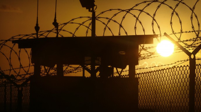 In this photo reviewed by the U.S. military, the sun rises above Camp Delta at Guantanamo Bay Naval Base, Cuba, Wednesday, Nov. 20, 2013. During nearly 12 years of legal disputes and political battles, the United States has put off deciding the fate of al-Qaida and Taliban militants held at Guantanamo Bay, captured after the Sept. 11 attacks but denied quick or full access to the American justice system. (AP Photo/Charles Dharapak)