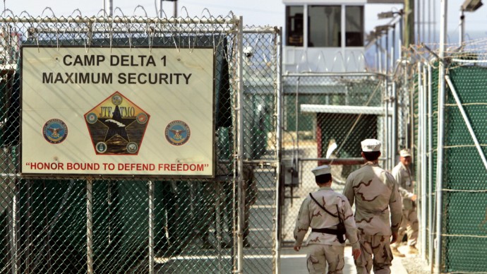 In this photo made June 27, 2006, U.S. military guards walk within Camp Delta military-run prison, at the Guantanamo Bay U.S, where some of the CIA torture is alleged to have taken place.  (AP Photo/Brennan Linsley)