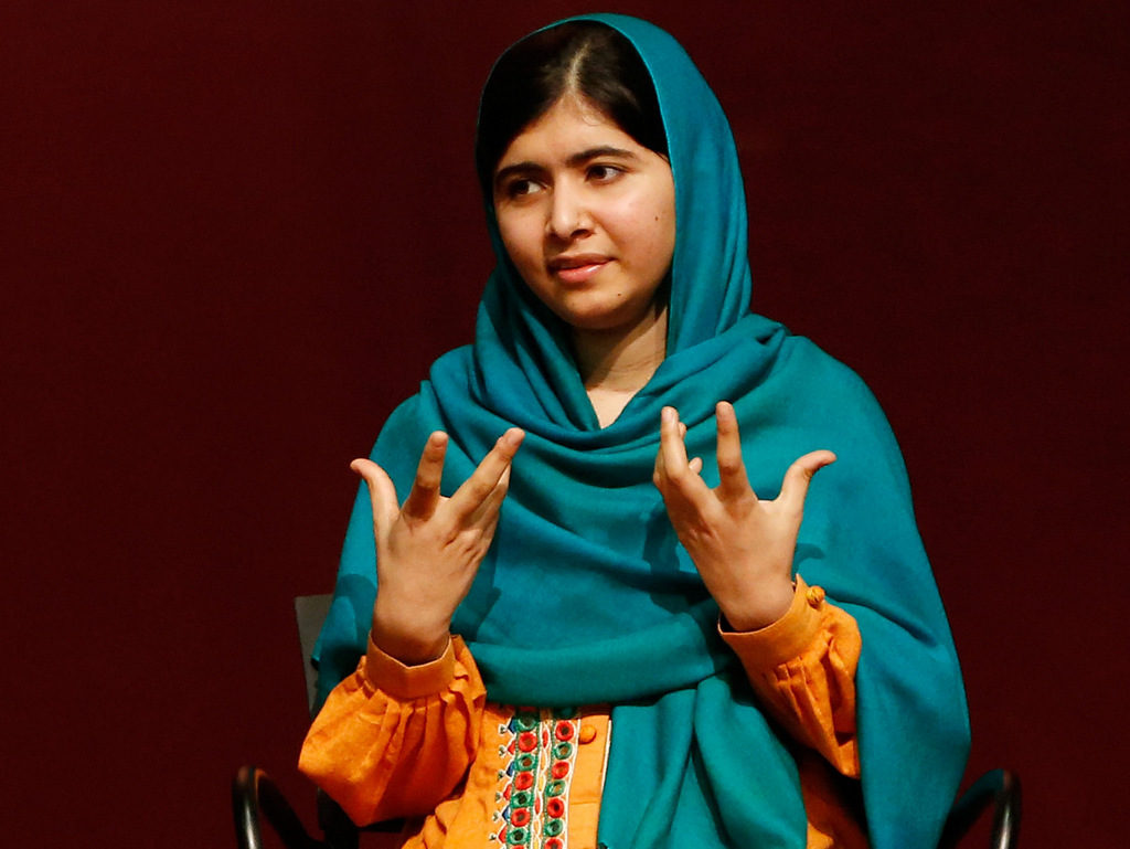 Malala Yousafzai gestures as she speaks to an audience during a discussion of her book, "I am Malala" hosted by the John F. Kennedy Library and held at Boston College High School Saturday, Oct. 12, 2013, in Dorchester, Mass. The Pakistani teenager, an advocate for education for girls, survived a Taliban assassination attempt last year on her way home from school. (AP Photo/Jessica Rinaldi)