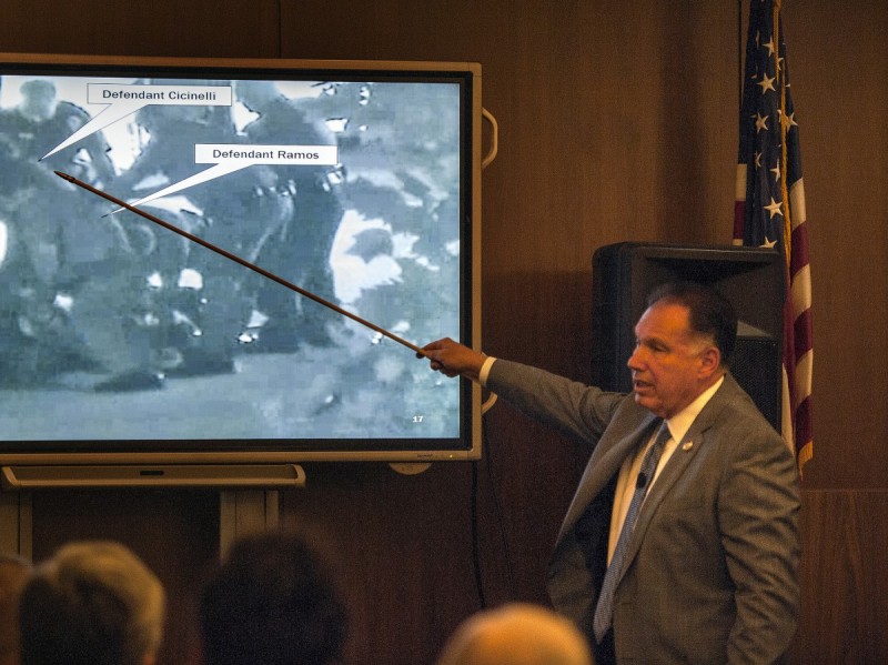 Orange County District Attorney Tony Rackauckas shows the jury an image of Fullerton police trying to subdue Kelly Thomas at the Fullerton Transportation Center on July 5, 2011 during the trial of former Fullerton officers Manuel Ramos and Jay Cicinelli on Monday, Dec. 2, 2013 in Santa Ana, Calif.  (AP Photo/The Orange County Register, Bruce Chambers, Pool)