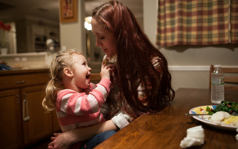 Maggie Barcellano sits down for dinner with her daughter, Zoe, 3, at Barcellano's father's house in Austin, Texas on Saturday, Jan. 25, 2014. Barcellano, who lives with her father, enrolled in the food stamps program to help save up for paramedic training while she works as a home health aide and raises her daughter. a (AP Photo/Tamir Kalifa)