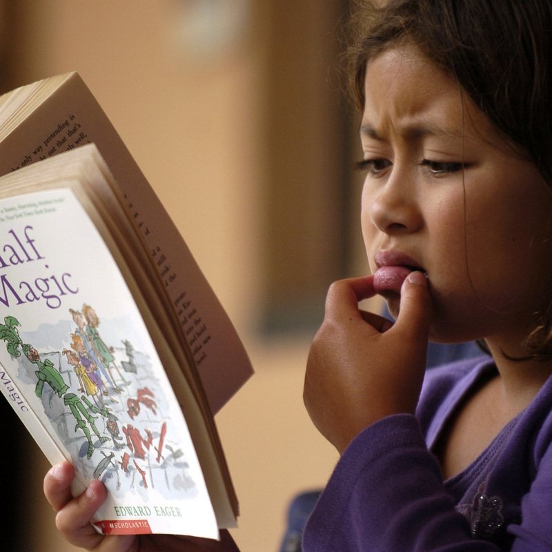 Claire Talbott, 7, of San Francisco, reads during a news conference addressing California Standardized Testing. (AP Photo/Benjamin Sklar)