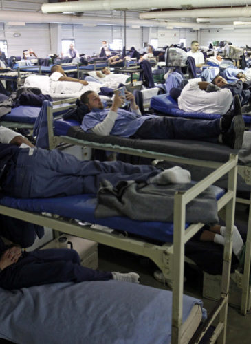 A room full of inmates are seen in their bunk beds at Southeastern Correctional Institution Wednesday, April 22, 2009 in Lancaster, Ohio. Ohio's prisons are at 132 percent capacity and space is squeezing tighter by the day, says prisons director Terry Collins. It's a nationwide problem as the economy escalates crime-causing tensions, worrying prison directors who must contend with the discomfort, violence, facility fatigue and lack of adequate programming staff. (AP Photo/Kiichiro Sato)
