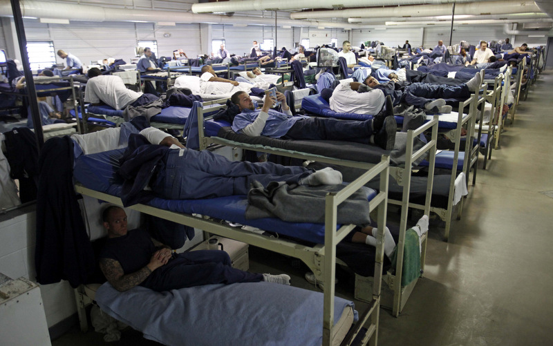  A room full of inmates are seen in their bunk beds at Southeastern Correctional Institution Wednesday, April 22, 2009 in Lancaster, Ohio. Ohio's prisons are at 132 percent capacity and space is squeezing tighter by the day, says prisons director Terry Collins. It's a nationwide problem as the economy escalates crime-causing tensions, worrying prison directors who must contend with the discomfort, violence, facility fatigue and lack of adequate programming staff. (AP Photo/Kiichiro Sato)