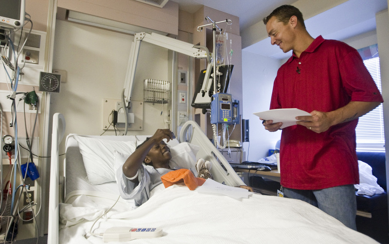 11-year-old Jonelle Bailey takes a picture of Detroit Tigers All-Star Brandon Inge from her hospital bed during a visits by the third baseman to the University of Michigan Mott Children's Hospital. (AP Photo/Tony Ding)