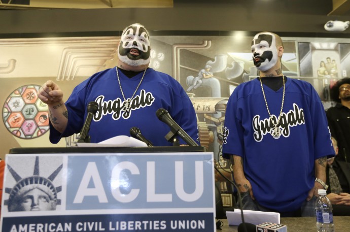 Joseph Bruce aka Violent J, left, and Joseph Utsler aka Shaggy 2 Dope, member of the Insane Clown Posse address the media in Detroit, Wednesday, Jan. 8, 2014. The rap metal group sued the U.S. Justice Department on Wednesday over a 2011 FBI report that describes the duo's devoted fans, the Juggalos, as a dangerous gang, saying the designation has tarnished their fans' reputations and hurt business. The American Civil Liberties Union filed the lawsuit in Detroit federal court on behalf of the group's two members. (AP Photo/Carlos Osorio)