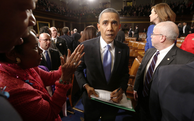 President Barack Obama sings autographs for members of Congress after giving the State of Union address before a joint session of Congress in the House chamber Tuesday, Jan. 28, 2014, in Washington. (AP Photo/Larry Downing, Pool)