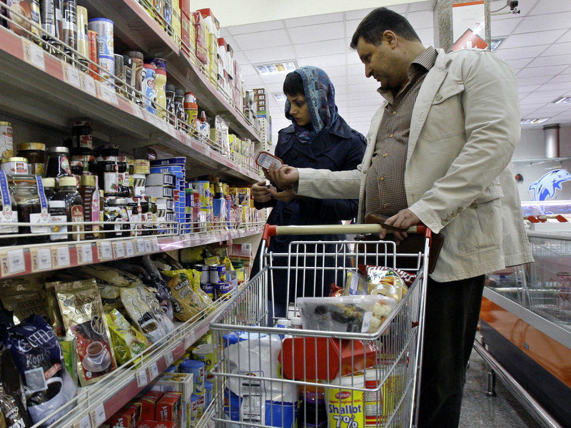 In this photo taken on Wednesday, Oct. 24, 2012, Iranians shop in a supermarket in Tehran, Iran. (AP Photo/Vahid Salemi)