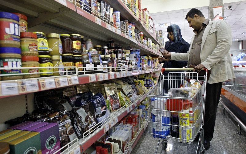 In this photo taken on Wednesday, Oct. 24, 2012, Iranians shop in a supermarket in Tehran, Iran. (AP Photo/Vahid Salemi)