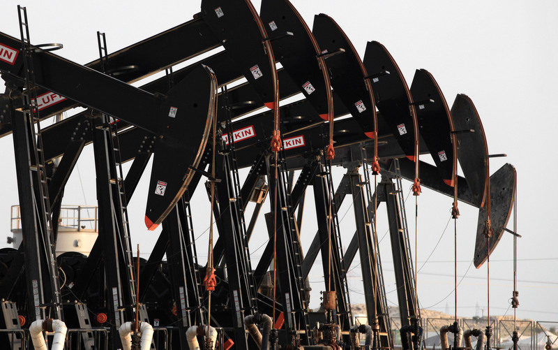 Oil pumps work Tuesday, Jan. 14, 2014, in the Persian Gulf desert oil field of Sakhir, Bahrain. (AP Photo/Hasan Jamali)
