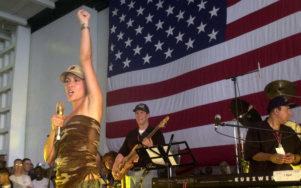 Actress Alyssa Milano speaks to crewmembers during a visit aboard USS Nimitz for a USO show. (Photo by  Sandra Palumbo/WikiMedia Commons)