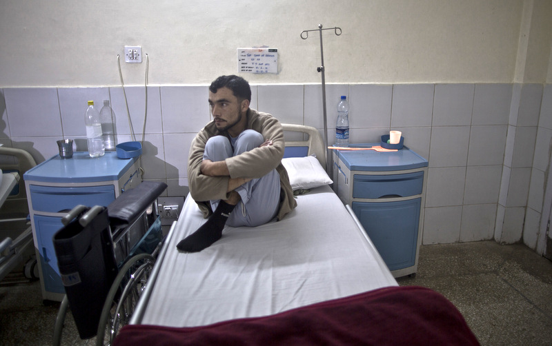 A Pakistani soldier who were injured by an improvised explosive device planted by militants in Pakistan's tribal areas, rests in his bed, at the Armed Forces Institute for Rehabilitation Medicine in Rawalpindi, Pakistan. (AP Photo/Muhammed Muheisen)